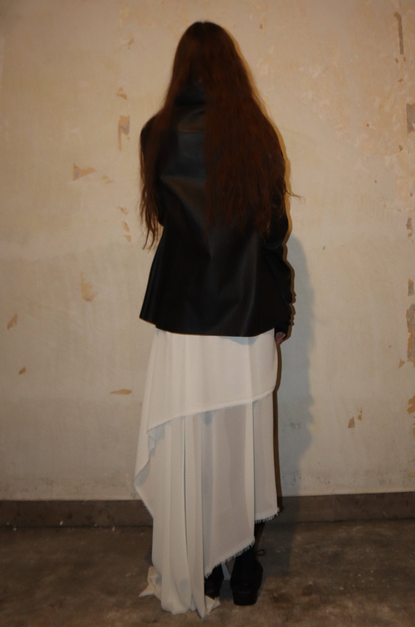 Maison Isabel Maciel - Asymmetric horse leather jacket with twisted sleeves, featured in lookbook.