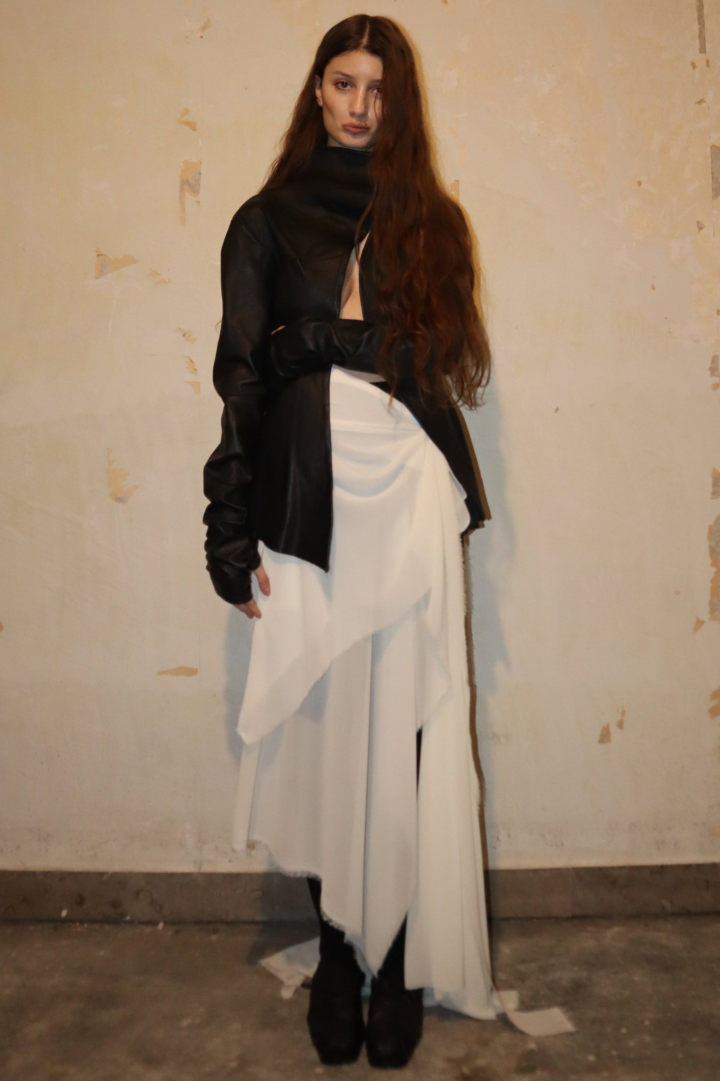 Maison Isabel Maciel - Asymmetric horse leather jacket with twisted sleeves, featured in lookbook.